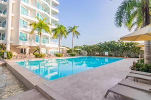 a swimming pool in front of a building at Sonesta Hotel Cartagena in Cartagena de Indias