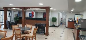 a restaurant with a table and chairs and a counter at Red Roof Inn Leeds in Leeds