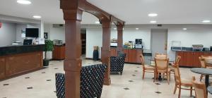 a restaurant with a table and chairs and a bar at Red Roof Inn Leeds in Leeds