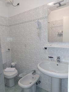 a white bathroom with a sink and a toilet at San Antonio 50 CA del MOETTO in Riomaggiore +19 photos