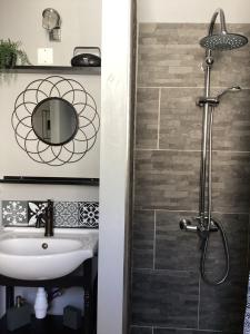 a bathroom with a sink and a shower at Les Apparts' Hotel du Canal in Châteaulin +94 photos