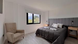 a bedroom with a bed and a chair and a window at Marea Baja - Casa con vista al mar para 6 PAX con parrilla en Cruz del Sur, Chapadmalal - Hola Sur in Chapadmalal +26 photos