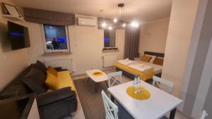 a small living room with a couch and a table at Apartamenty Rynek 21 in Muszyna