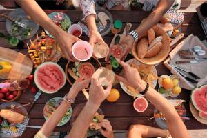 a group of people drinking wine at a table with food at Camping Saint-Laurent-du-Verdon in Saint-Laurent-du-Verdon