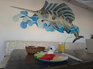 a plate of food on a table with a fish on the wall at Guest House Compass in Lozenets