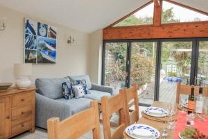 a living room with a couch and a table at Shipwrights, 11 Coronation Road in Salcombe