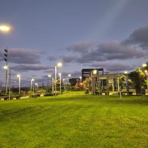 a park with a playground and street lights at night at Guest House Compass in Lozenets