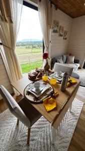 a table with a plate of food on it in a room at Tiny House Beija-Flor in Challex +53 photos