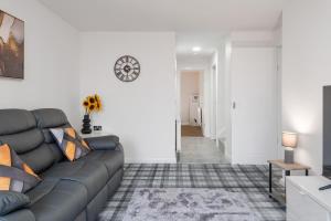 a living room with a couch and a table at Creel Cottage, Peterhead in Peterhead