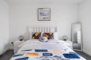 a bedroom with a bed with a stuffed animal on it at Creel Cottage, Peterhead in Peterhead