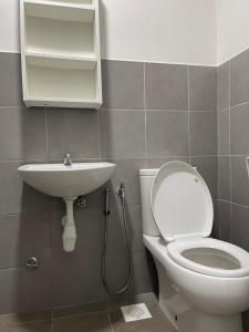 a bathroom with a toilet and a sink at Nafisa Homestay in Kepala Batas