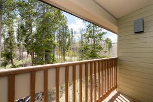 a balcony with a large window looking out into the woods at Silverado II Unit 334 in Winter Park