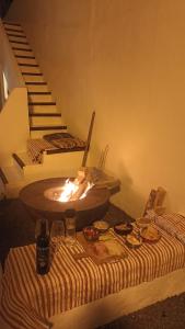 a room with a table with a fire pit and stairs at Olala House Lanzarote in Haría