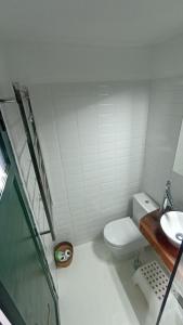 a bathroom with a toilet and a sink at Olala House Lanzarote in Haría