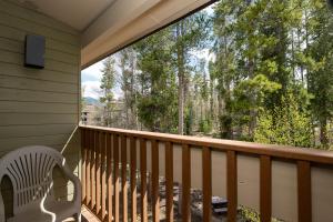 a porch with a white chair and a large window at Silverado II Unit 334 in Winter Park