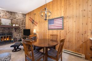 a dining room with a table and an american flag on the wall at Silverado II Unit 334 in Winter Park