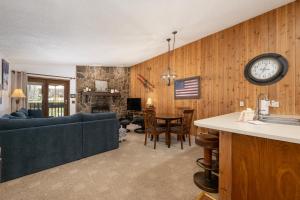 a living room with a couch and a clock on the wall at Silverado II Unit 334 in Winter Park +35 photos