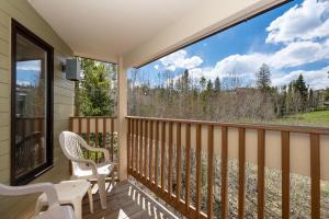 a balcony with a table and chairs and a large window at Silverado II Unit 334 in Winter Park