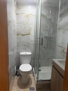 a bathroom with a shower and a toilet and a sink at Elegant Getaway - Spacious 3 Bedroom Apartment -Lisbon Baixa da Banheira in Lavradio +5 photos