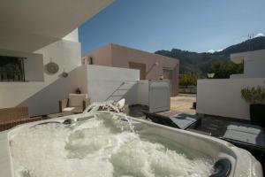 a bath tub with water in it on a patio at Stergios Suite with Private Jacuzzi in Kolymbia