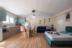 a living room with a bed and a kitchen at Stergios Suite with Private Jacuzzi in Kolymbia