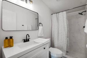 a white bathroom with a sink and a shower at Starlight Horizon in Canyon Lake +50 photos