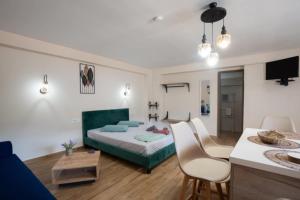 a bedroom with a bed and a table and chairs at Stergios Suite with Private Jacuzzi in Kolymbia