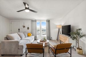 a living room with a couch and a ceiling fan at Starlight Horizon in Canyon Lake