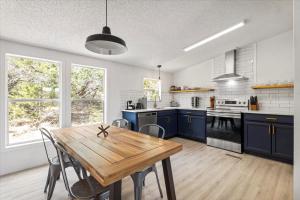 a kitchen with blue cabinets and a wooden table at Starlight Horizon in Canyon Lake