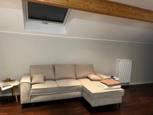 a living room with a couch with a flat screen tv at Ferienwohnung Brönnleins in Koblenz +3 photos