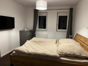 a bedroom with a bed and a flat screen tv at Ferienwohnung Brönnleins in Koblenz