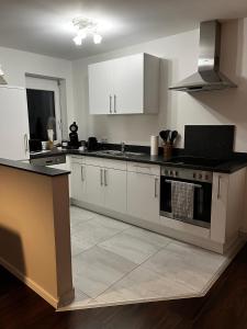 a kitchen with white cabinets and a stove at Ferienwohnung Brönnleins in Koblenz
