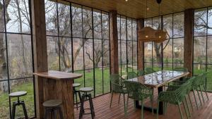 a room with a table and chairs and windows at Doftana 609 in Trăisteni