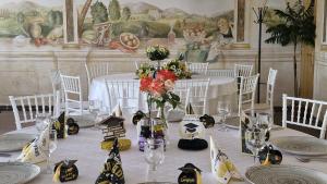 a table with white tablecloths and flowers on it at Hotel Casa Traiana in Alba Iulia +16 photos