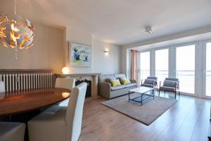 a living room with a table and a dining room at Lecomte - The Shoreline Collection 6 in Ostend