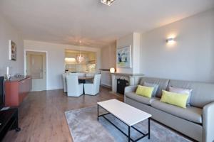 a living room with a couch and a table at Lecomte - The Shoreline Collection 6 in Ostend +22 photos