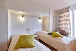 a hotel room with two beds and a window at Lecomte - The Shoreline Collection 6 in Ostend