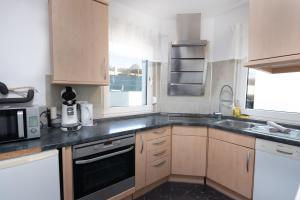 a kitchen with a sink and a stove top oven at Schöne moderne 2-Zimmerwohnung in Göppingen