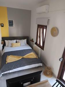 a bedroom with a bed with a yellow blanket at Kala Nera seaside bnb in Kala Nera