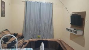 a living room with a window with a curtain at Condominio Nina2 in Icapuí