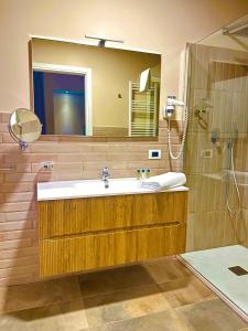 a bathroom with a sink and a shower and a mirror at Home 146 in Lamezia Terme +64 photos