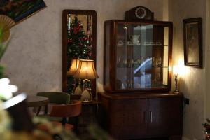 a living room with a christmas tree and a cabinet at SMALL Boutique & Garden in Tirana