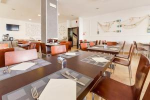 a dining room with wooden tables and chairs at Nuovo Hotel Diamante in Cesenatico