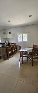 a dining room with a table and wooden chairs at Pousada Behling Haus in Pomerode