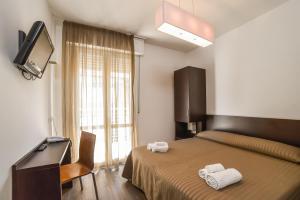 a bedroom with a bed with two towels on it at Nuovo Hotel Diamante in Cesenatico +86 photos