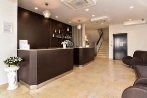 a lobby with a bar with chairs and a staircase at Nuovo Hotel Diamante in Cesenatico