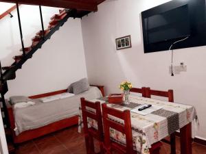 a room with a table and a bed and a television at Alojamiento - Apart Hotel Libres - Hospedaje in Paso de los Libres
