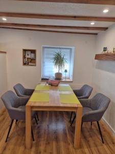a dining room with a wooden table and chairs at Ferienwohnung Sigwart in Efringen-Kirchen