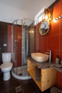 a bathroom with a sink and a shower and a toilet at Stergios top view residence with jacuzzi in Kolymbia +18 photos