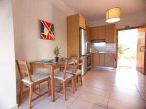 a kitchen and dining room with a wooden table and chairs at Peris #2 - Souda in Souda +9 photos